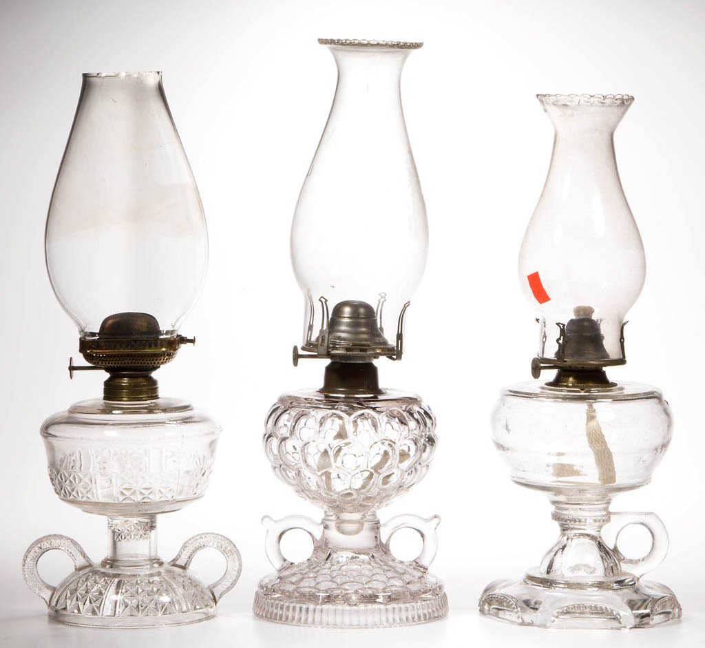 ASSORTED PATTERN FOOTED KEROSENE FINGER LAMPS, LOT OF (1 of 1)
