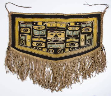 NATIVE AMERICAN NORTHWEST COAST CHILD'S CEREMONIAL: NATIVE AMERICAN NORTHWEST COAST CHILD'S CEREMONIAL CHILKAT BLANKET, the woven panel dyed yellow, blue-green, and black, depicting a central mask surrounded by clan symbols and stylized natural forms,