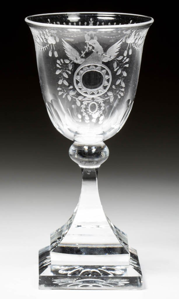 STEUBEN "STRAWBERRY MANSION" PATTERN CUT CORDIAL OR: STEUBEN "STRAWBERRY MANSION" PATTERN CUT CORDIAL OR WINE GLASS, colorless, shape 7238, spread-wing eagle crest, raised on a stepped square base, etched signature. Steuben Glass Works. Designed by Fred