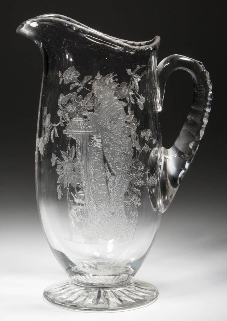 FRY "JAPANESE MAID" ETCHED GLASS BEVERAGE PITCHER: FRY "JAPANESE MAID" ETCHED GLASS BEVERAGE PITCHER, colorless, notched rim, applied honeycomb-cut handle, and star-cut foot. H. C. Fry Glass Co. Circa 1913. 10 3/4" HOA.Literature: Pattern as The Colle