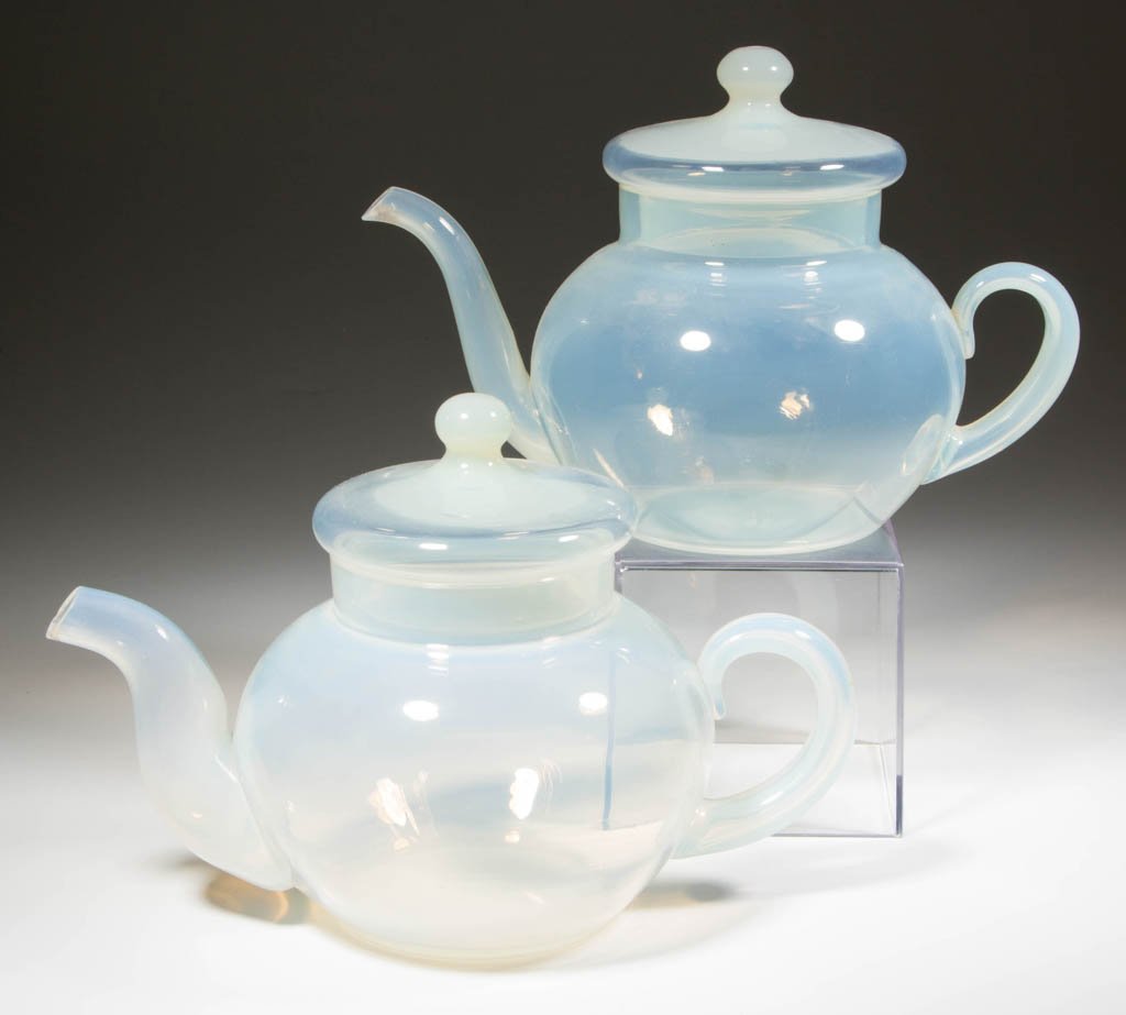 FRY FOVAL ART GLASS TEAPOTS, LOT OF TWO: FRY FOVAL ART GLASS TEAPOTS, LOT OF TWO, each shape #2000, with applied Foval handles. H. C. Fry Glass Co. First half 20th century. 6 3/8" to 6 1/2" HOA. Literature: Parallels The Collector's Encyclop