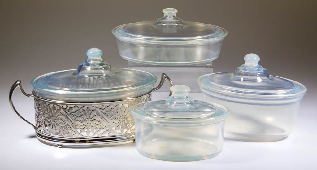 FRY OVENWARE CASSEROLES, LOT OF FOUR: FRY OVENWARE CASSEROLES, LOT OF FOUR, opalescent, each with cover, one with a metal holder. H. C. Fry Glass Co. First half 20th century. 3 1/2" to 5 3/4" HOA. Literature: Parallels The Collector's Enc