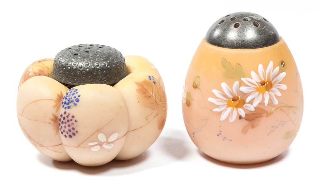 MT. WASHINGTON FIGURAL SALT SHAKERS, LOT OF TWO: MT. WASHINGTON FIGURAL SALT SHAKERS, LOT OF TWO, over-fired Burmese (uranium), comprising an upright Egg and Tomato, each with polychrome-enamel floral decoration, plush/satin finish, and period lid. 