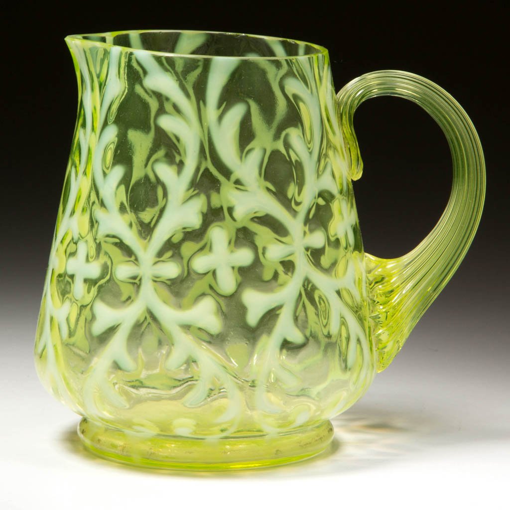 OPALINE BROCADE / SPANISH LACE CREAMER: OPALINE BROCADE / SPANISH LACE CREAMER, Vaseline (uranium) opalescent, with an applied Vaseline (uranium) reeded handle and factory-polished rim. Northwood Glass Co. Circa 1899. 4 3/8" H.Literature: P