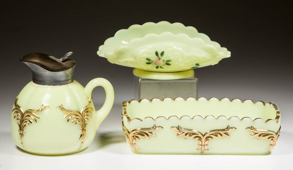 HEISEY NO. 1280 / WINGED SCROLL TABLE ARTICLES, LOT OF: HEISEY NO. 1280 / WINGED SCROLL TABLE ARTICLES, LOT OF THREE, custard (uranium), with polychrome or gilt decoration, comprising a syrup with gilt decoration, a rectangular tray with gilt decoration, a