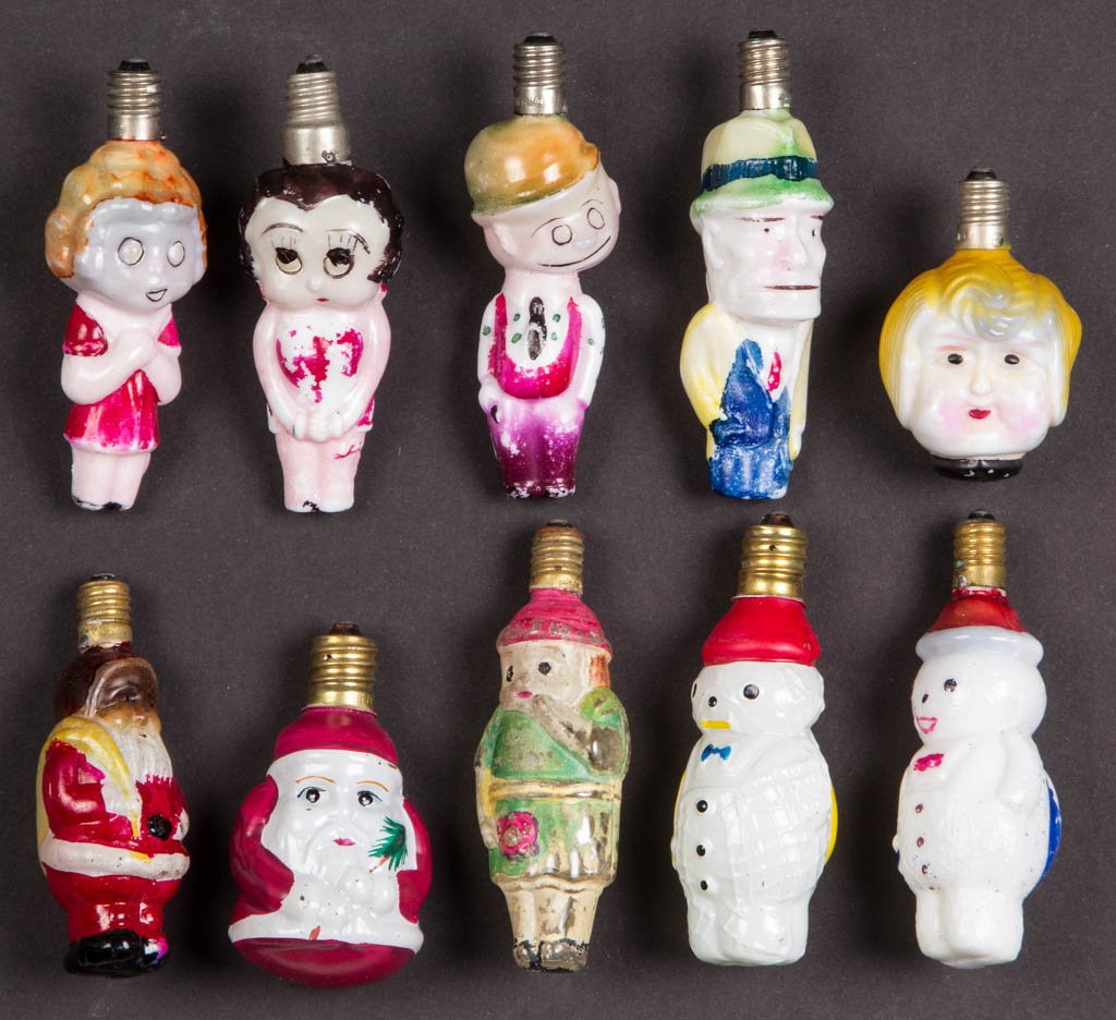 ASSORTED FIGURAL CHRISTMAS ELECTRIC BULBS, LOT OF TEN: ASSORTED FIGURAL CHRISTMAS ELECTRIC BULBS, LOT OF TEN, opaque white and colorless glass with polychrome decoration, including Little Orphan Annie, Betty Boop, Dick Tracy, and Santa Claus. First half 2