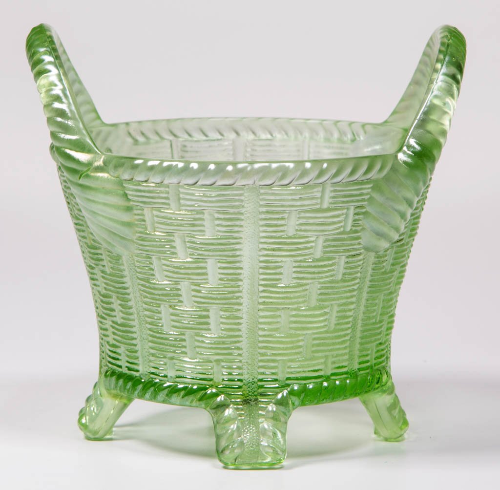 NORTHWOOD BUSHEL BASKET CARNIVAL GLASS BOWL: NORTHWOOD BUSHEL BASKET CARNIVAL GLASS BOWL, ice green, raised on four feet, signed. H. Northwood Co. First quarter 20th century. 4 3/4" H.Provenance: Collection of the late Jerry Volkmer, Bucyrus, OH