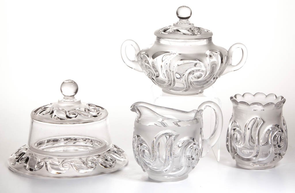 FOSTORIA NO. 183 / VICTORIA FOUR-PIECE TABLE SET: FOSTORIA NO. 183 / VICTORIA FOUR-PIECE TABLE SET, colorless and frosted, comprising a covered butter dish, covered sugar bowl, creamer, and spooner; the latter three with embossed "PATD" to underside.