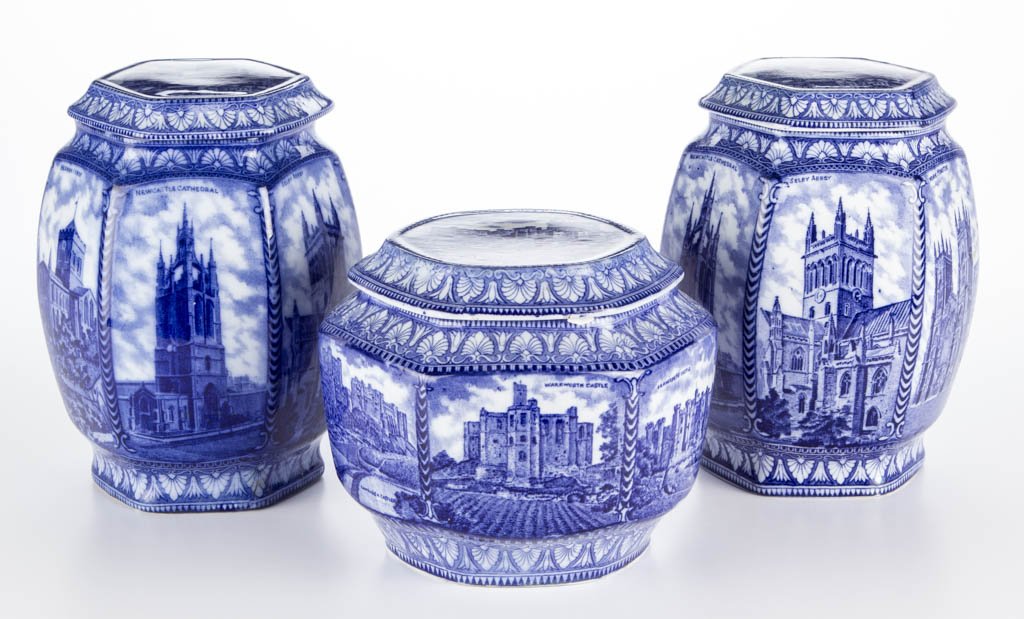 ENGLISH STAFFORDSHIRE IRONSTONE TEA- AND BISCUIT-: ENGLISH STAFFORDSHIRE IRONSTONE TEA- AND BISCUIT- BARRELS, LOT OF THREE, comprising a pair of tall and a single low hexagonal-paneled barrel-form containers and covers, transfer-printed in medium blue