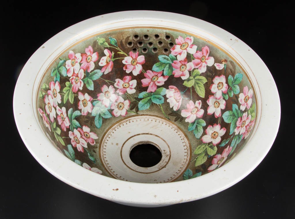 ENGLISH STAFFORDSHIRE CERAMIC SINK: ENGLISH STAFFORDSHIRE CERAMIC SINK, hemispherical form with flanged rim, side overflow, and drain hole in base, interior with hand-painted polychrome enamel wild rose decoration. Printed and stamped m
