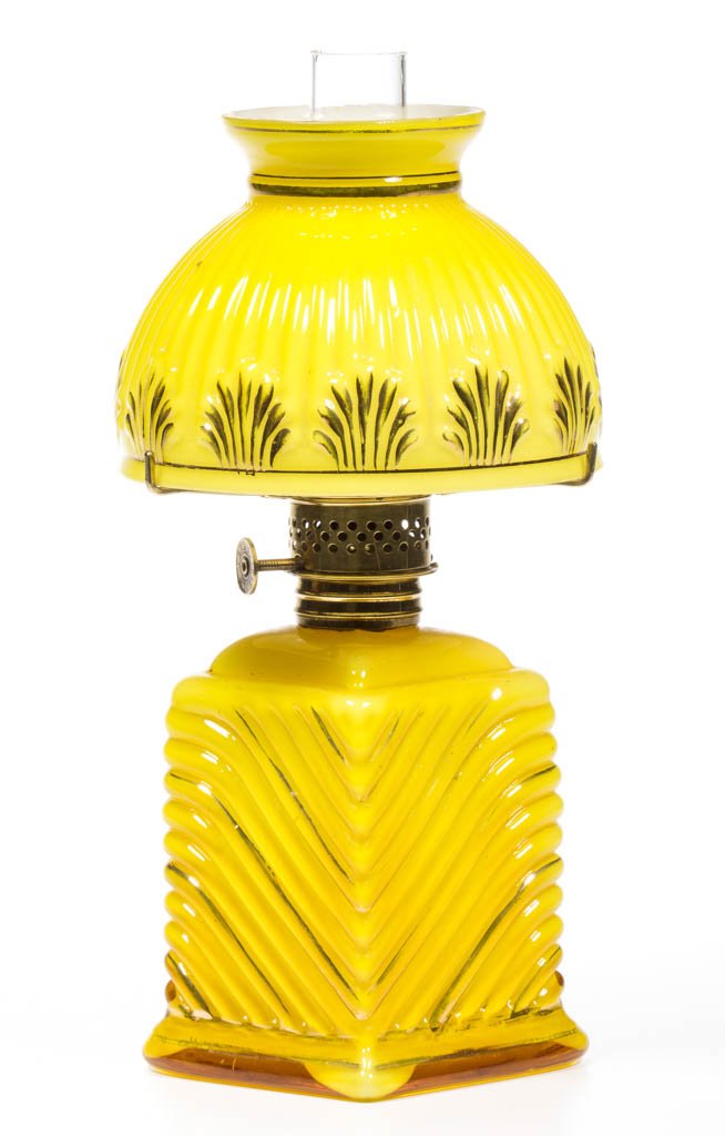 CHEVRON RIB CASED GLASS MINIATURE LAMP: CHEVRON RIB CASED GLASS MINIATURE LAMP, cased lemon yellow with gilt highlights, diamond-form with swirling ribs, appropriate vertical ribs over shells patterned umbrella-form shade, period collar. Fi