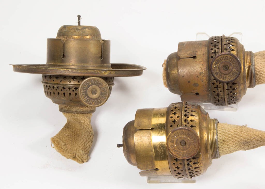 MOEHRING KEROSENE BURNERS, LOT OF THREE: MOEHRING KEROSENE BURNERS, LOT OF THREE, each having complete internal mechanics, one example having a shade ring, thumbwheels embossed, "H. G. MOEHRING." Hibbard, Spencer, Bartlett & Co. Circa 1893. 