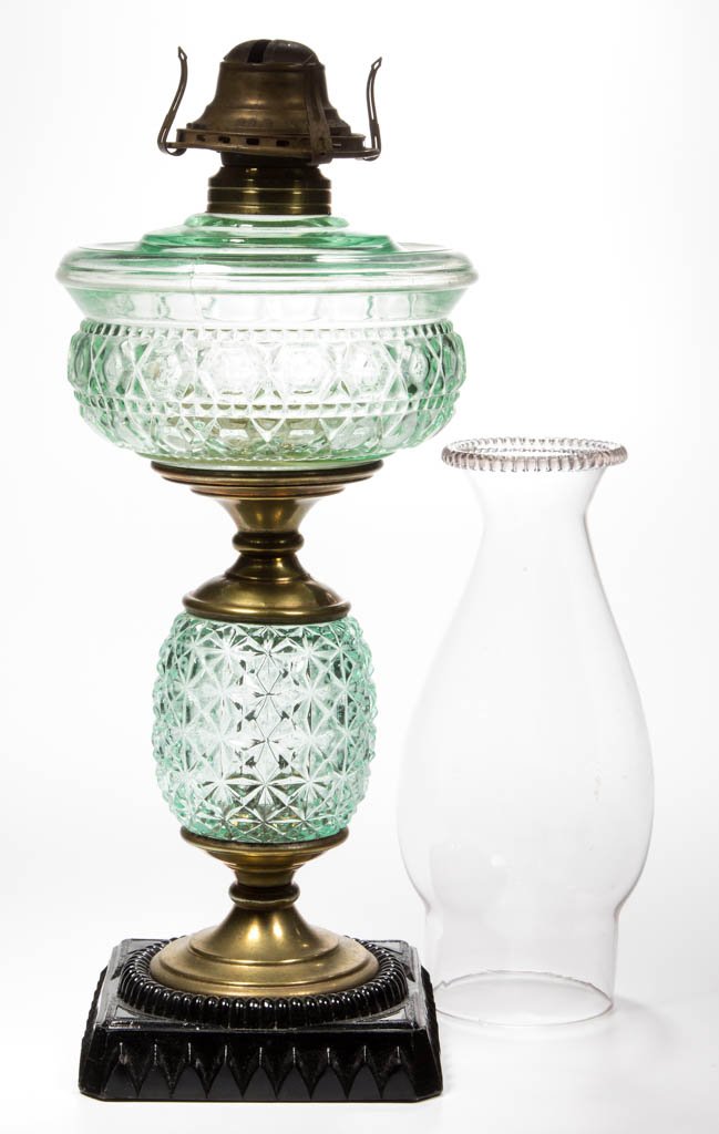 ADAMS NO. 207 STAND LAMP: ADAMS NO. 207 STAND LAMP, apple green font and stem, font with drip-catcher edge shoulder, opaque black glass square base with inner upright ribs and arches/petals around the base, brass connectors, N