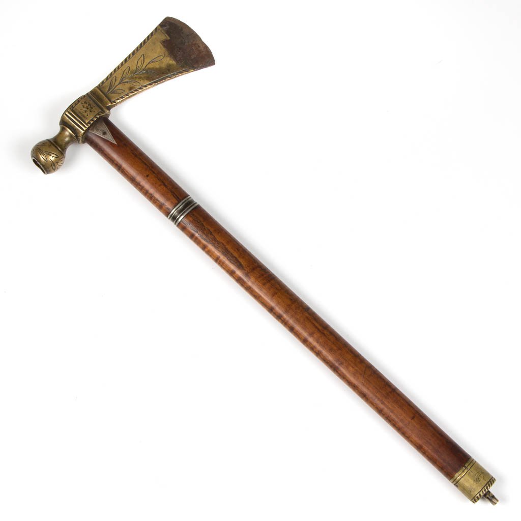 NATIVE AMERICAN PIPE TOMAHAWK: NATIVE AMERICAN PIPE TOMAHAWK, brass head with steel inset blade, brass mouthpiece/pommel, German silver band around haft and two triangular inserts pointing down from neck. Probably early to mid 19th