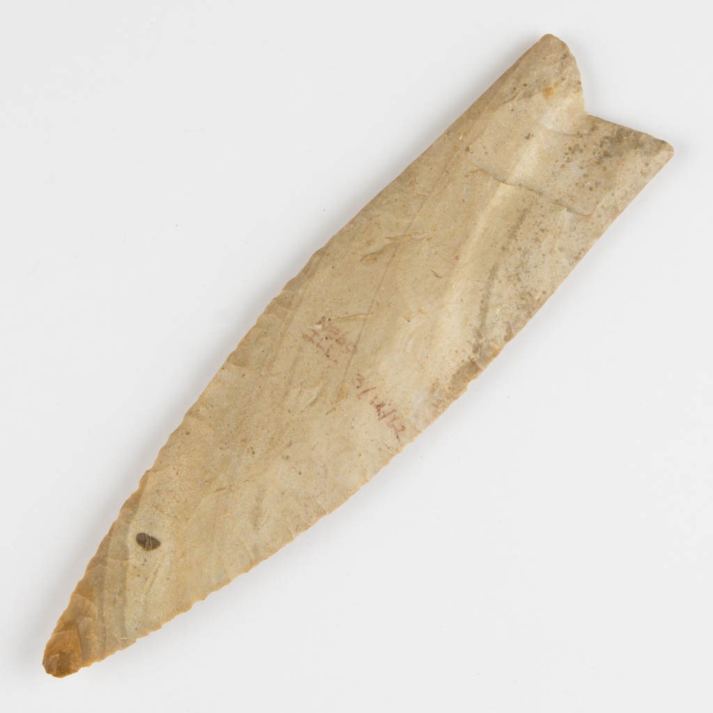 NATIVE AMERICAN STONE POINT: NATIVE AMERICAN STONE POINT, fluted lanceolate, concave base. Marked "Nebo, Ill. 3/12/62" to one face in ink. Attributed by William Jack Hranicky as Dalton (Sloan-type) point, possibly Clovis point. A