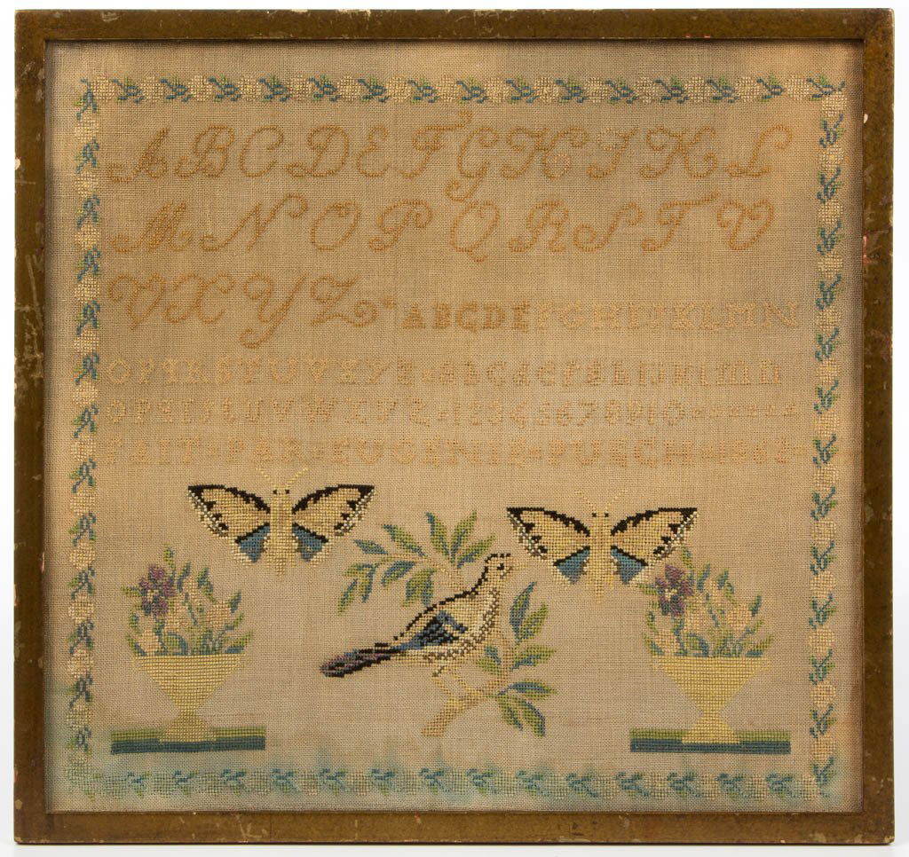 EUGENIA PUEGH PICTORIAL NEEDLEWORK SAMPLER: EUGENIA PUEGH PICTORIAL NEEDLEWORK SAMPLER, silk on linen, having five alphabet and numeral rows over inscription "Fait. Par. Eugenia Puegh. 1862" above a lower panel featuring opposing flowering urns