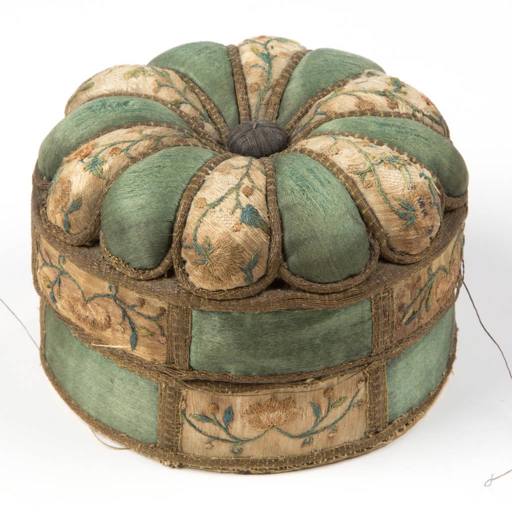 SILK AND EMBROIDERED SEWING BOX WITH PINCUSHION TOP: SILK AND EMBROIDERED SEWING BOX WITH PINCUSHION TOP, circular form with lift-off melon-form cover, alternating panels of white with floral embroidery and green panels highlighted in gold metallic thre