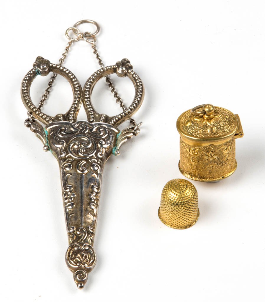 ASSORTED METALS CHATELAINE ARTICLES, LOT OF TWO: ASSORTED METALS CHATELAINE ARTICLES, LOT OF TWO, comprising sterling silver scissors with beading pattern and fitted in a silver-like sheath with attached chain; and a gold-washed thimble case with st