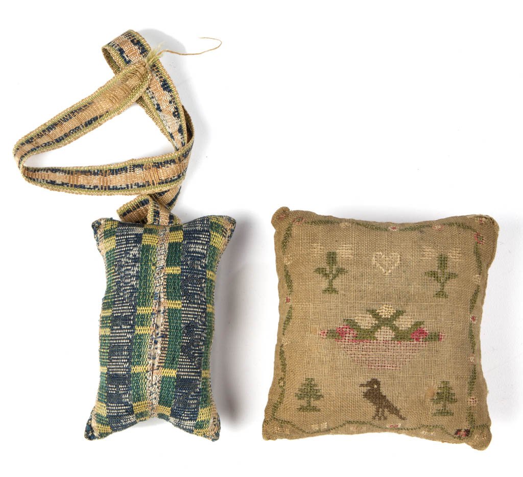 SIGNED AND EMBROIDERED PINCUSHIONS, LOT OF TWO: SIGNED AND EMBROIDERED PINCUSHIONS, LOT OF TWO, comprising a square example marked "Mary Bullock 1829" and surrounded by potted plants, lions and diamonds within a pink border, reverse with a heart, b