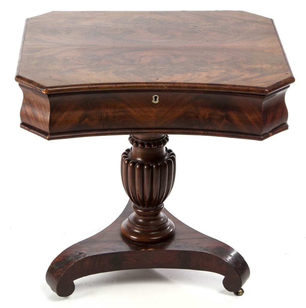 AMERICAN CLASSICAL MAHOGANY SEWING STAND: AMERICAN CLASSICAL MAHOGANY SEWING STAND, the hinged rectangular top with cut corners, concealing an elaborately appointed burlwood interior fitted with turned bone knobs, raised on a fluted urn-and r
