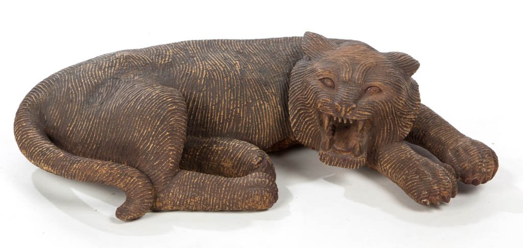 FOLK ART CARVED TIGER / CAT FIGURE: FOLK ART CARVED TIGER / CAT FIGURE, a sizable example, carved from the solid, depicting a snarling feline in a prone position, with old brown-painted surface. Discovered in Kentucky. 20th century. 6 1