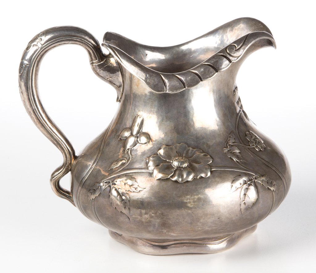 GORHAM MARTELE STERLING SILVER WATER PITCHER: GORHAM MARTELE STERLING SILVER WATER PITCHER, a fine example of hand-hammered Art Nouveau design, bulbous body with everted mouth rim having shaped edge, complex tapered scrolling handle with leaf-for