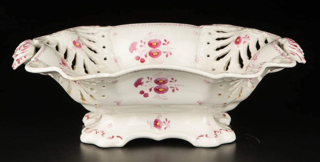 ENGLISH STAFFORDSHIRE OR YORKSHIRE POTTERY CREAMWARE: ENGLISH STAFFORDSHIRE OR YORKSHIRE POTTERY CREAMWARE BASKET, of scallop-molded rectangular form, the corners pierced in fan-form foliate and dot patterns, the two handles applied under the everted rim