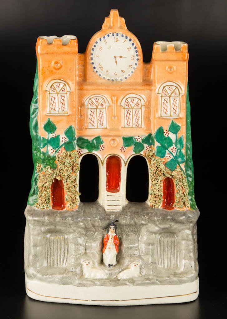 ENGLISH STAFFORDSHIRE POTTERY VICTORIAN FLATBACK MODEL: ENGLISH STAFFORDSHIRE POTTERY VICTORIAN FLATBACK MODEL OF A CASTLE, modeled in three tiers, with two turrets framing a large watch, over windows, the second tier with encrusted dried clay moss around