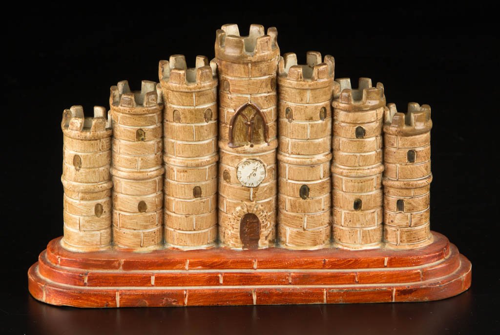 ENGLISH STAFFORDSHIRE POTTERY PEARLWARE CASTLE MODEL: ENGLISH STAFFORDSHIRE POTTERY PEARLWARE CASTLE MODEL, molded as seven connected cylindrical turrets of varying height from the central watch tower, on a stepped ovular base, painted in shades of brown
