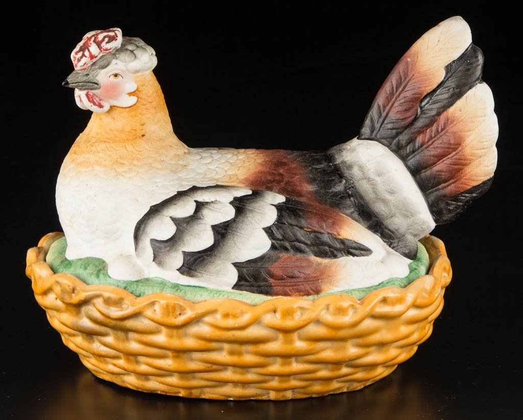 ENGLISH STAFFORDSHIRE POTTERY "NESTING HEN" TUREEN: ENGLISH STAFFORDSHIRE POTTERY "NESTING HEN" TUREEN, the cover modeled as a white hen with brown, black and gray feathers, seated on a grassy mound above her eggs, the lower section modeled as a basket