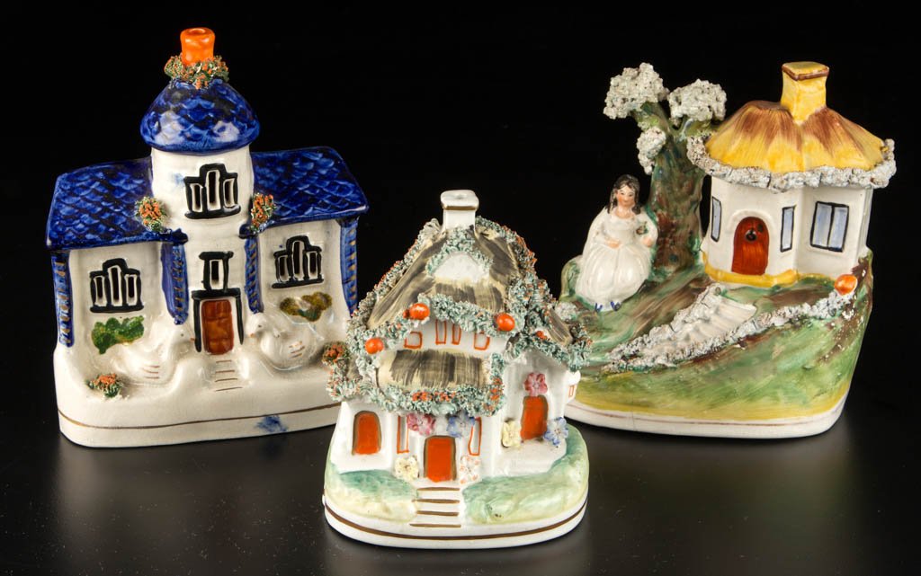 ENGLISH STAFFORDSHIRE POTTERY COTTAGES AND A: ENGLISH STAFFORDSHIRE POTTERY COTTAGES AND A COTTAGE-FORM PASTILLE BURNER, LOT OF THREE, comprising a cottage on a high mound with steps cut into the front, a girl under tree to the back, a cottage wi