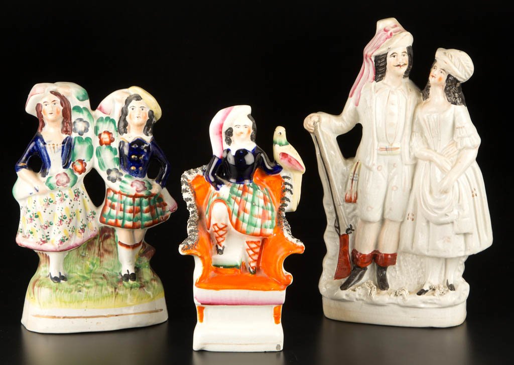 ENGLISH STAFFORDSHIRE POTTERY FIGURES OF HIGHLAND SCOTS: ENGLISH STAFFORDSHIRE POTTERY FIGURES OF HIGHLAND SCOTS INTEREST, LOT OF THREE, comprising a colorful figure of Alexandra, the Princess Royal in her tartans, standing on a throne chair, holding a bird