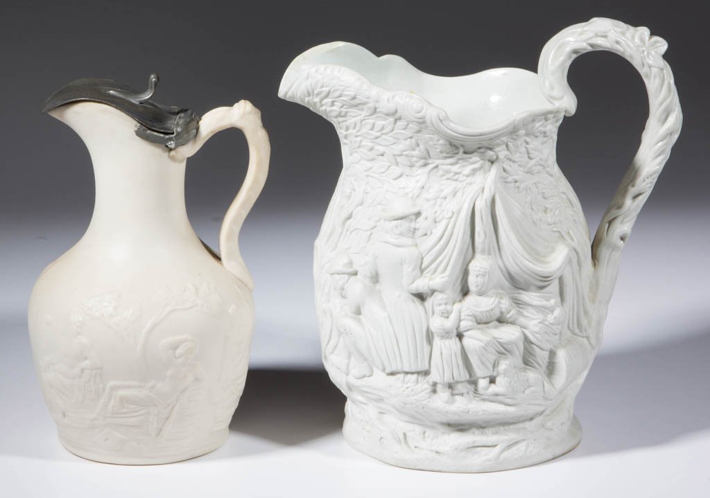 ENGLISH CERAMIC PITCHERS, LOT OF TWO: ENGLISH CERAMIC PITCHERS, LOT OF TWO, comprising a Parian example with classical figures and hinged pewter lid, and a white stoneware example molded in the elaborate "Gipsey" pattern, underside with p