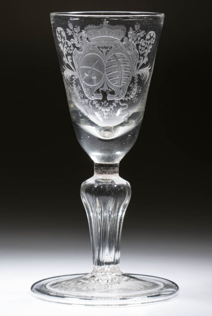 CONTINENTAL FREE-BLOWN AND ENGRAVED MOLDED-PEDESTAL: CONTINENTAL FREE-BLOWN AND ENGRAVED MOLDED-PEDESTAL POKAL / LARGE WINE GLASS, colorless non-lead glass, pointed round funnel bowl with finely executed armorial crest on front and a draped crest with m