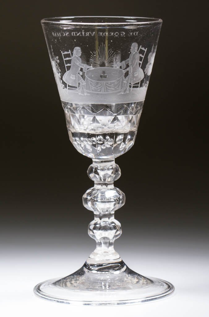 CONTINENTAL FREE-BLOWN, CUT, AND ENGRAVED FACET-STEM: CONTINENTAL FREE-BLOWN, CUT, AND ENGRAVED FACET-STEM POKAL, colorless non-lead glass, round funnel bowl with an outdoor scene of two gentlemen seated at a table, each holding a wine glass, a wine bott