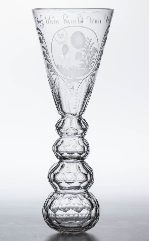 CONTINENTAL FREE-BLOWN, CUT, AND ENGRAVED STIRRUP CUP: CONTINENTAL FREE-BLOWN, CUT, AND ENGRAVED STIRRUP CUP, colorless non-lead glass, deep pointed round funnel bowl with a reserve featuring a sun with face above a sunflower and flame-top heart, German i