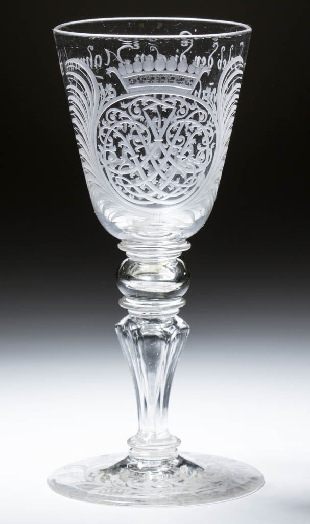 CONTINENTAL FREE-BLOWN AND ENGRAVED MOLDED-PEDESTAL: CONTINENTAL FREE-BLOWN AND ENGRAVED MOLDED-PEDESTAL WINE GLASS, colorless non-lead glass, round funnel bowl with ornate armorial crest on front and three-line inscription to reverse, raised on a hollo