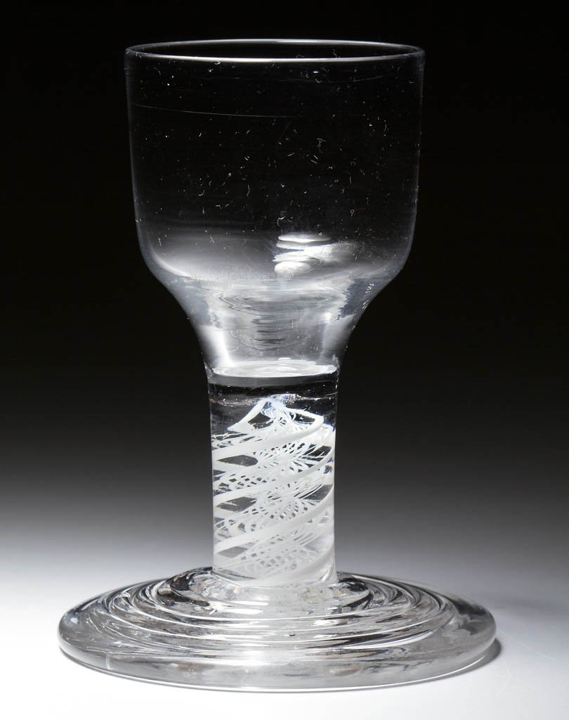 ENGLISH FREE-BLOWN OPAQUE-TWIST STEM FIRING GLASS: ENGLISH FREE-BLOWN OPAQUE-TWIST STEM FIRING GLASS, colorless lead glass, ogee bowl, raised on a stem containing a pair of heavy spiral threads outside a lace twist, thick conical terraced foot with ro
