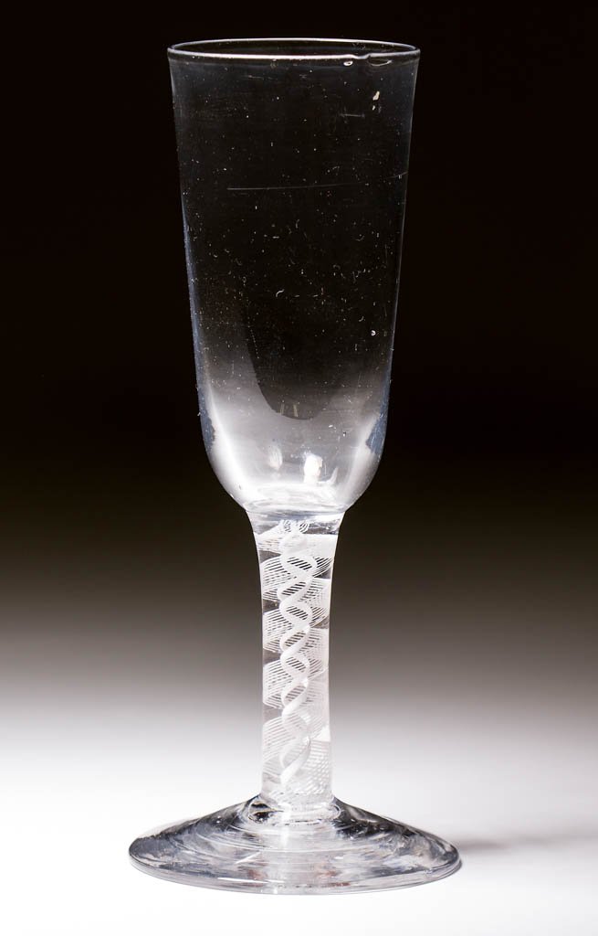 ENGLISH FREE-BLOWN OPAQUE-TWIST STEM WINE GLASS: ENGLISH FREE-BLOWN OPAQUE-TWIST STEM WINE GLASS, colorless lead glass, deep round funnel bowl, raised on a stem containing a 12-ply spiral band outside a pair of spiral tapes, conical foot with rough 