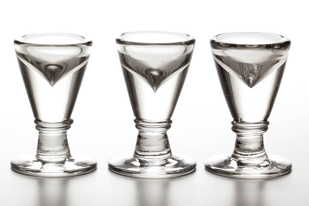BLOWN ICE CREAM PENNY LICK GLASSES, LOT OF THREE: BLOWN ICE CREAM PENNY LICK GLASSES, LOT OF THREE, colorless, each short conical bowl with a thick base, raised on a short stem with double-ring top and circular foot. Second half 19th century. 3 1/2"