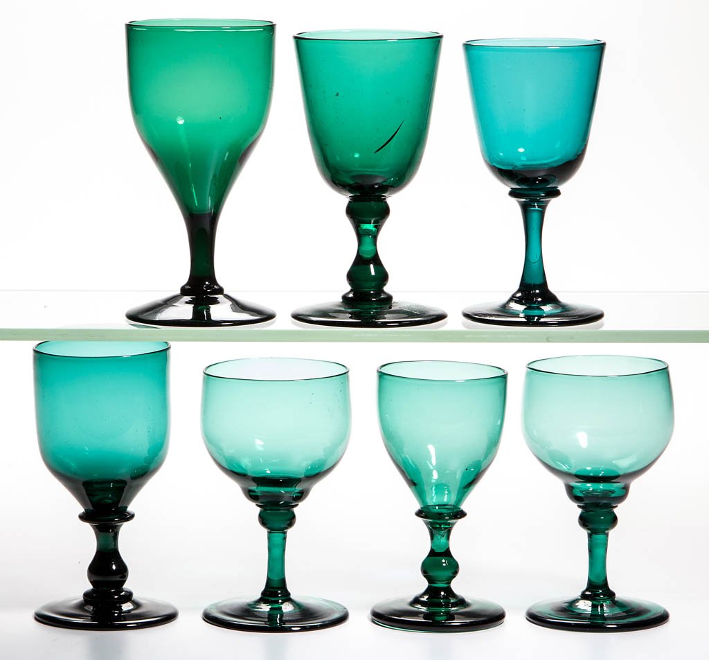 ENGLISH FREE-BLOWN COLORED GLASS WINE GLASSES, LOT OF: ENGLISH FREE-BLOWN COLORED GLASS WINE GLASSES, LOT OF SEVEN, various shades of green, five lead glass, including a pair with shoulder-knopped stem and three with baluster stem, rough and polished pont