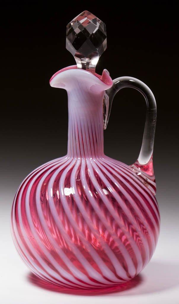 HOBBS NO. 325 / SWIRL CRUET: HOBBS NO. 325 / SWIRL CRUET, Ruby opalescent/cranberry opalescent, colorless applied handle, colorless cut-facet stopper, polished pontil mark. Hobbs, Brockunier & Co. Pattern introduced 1888. 6 1/2"