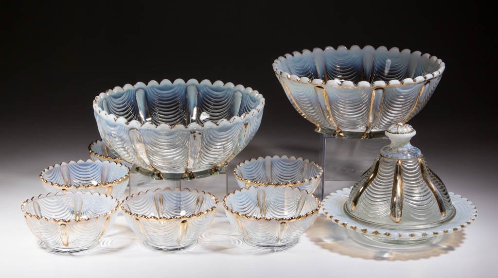 NORTHWOOD DRAPERY TABLE ARTICLES, LOT OF NINE: NORTHWOOD DRAPERY TABLE ARTICLES, LOT OF NINE, colorless opalescent with gilt decoration, comprising a covered butter dish, two master berry bowls, and six individual sauces/berry bowls. H. Northwood