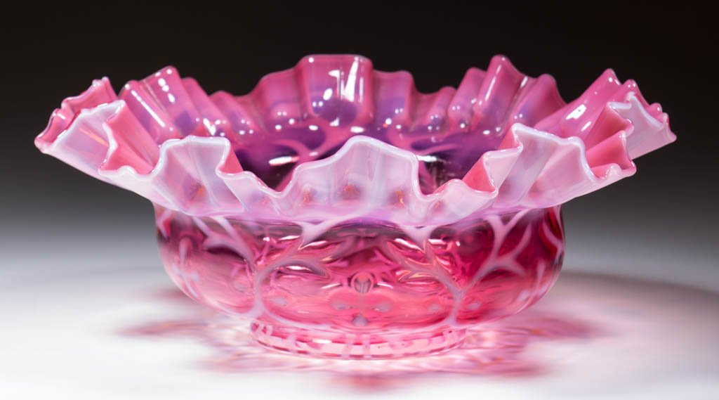 OPALINE BROCADE / SPANISH LACE BRIDE'S BASKET: OPALINE BROCADE / SPANISH LACE BRIDE'S BASKET, cranberry opalescent, crimped and ruffled rim. Northwood Glass Co/Dugan Glass Co. Pattern introduced 1899. 4" HOA, 10" DOA.Provenance: From the collectio