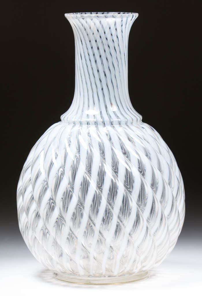 REVERSE SWIRL WATER BOTTLE: REVERSE SWIRL WATER BOTTLE, colorless opalescent, factory polished rim. Maker unverified. Circa 1888-1902. 8 1/4" H.Literature: Heacock / Elmore - Opalescent Glass A-Z, p. 96, center.Provenance: From