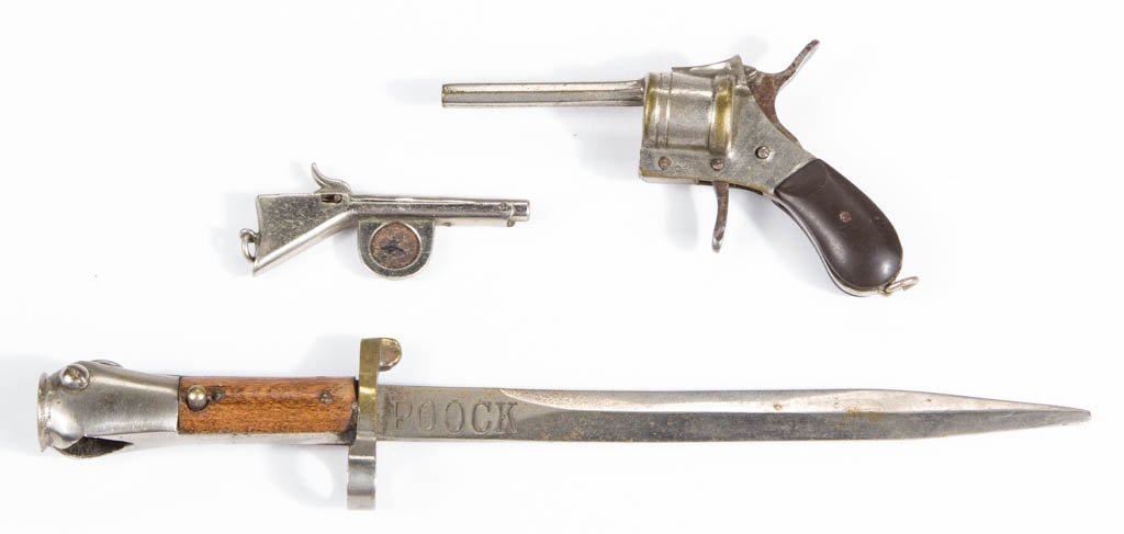FIGURAL MILITARIA CIGAR CUTTERS, LOT OF THREE: FIGURAL MILITARIA CIGAR CUTTERS, LOT OF THREE, comprising a revolver example with hammer operating the cutting blade, a rifle or shotgun example, and a bayonet-form example that could double as a lett
