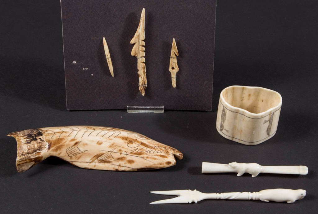 NATIVE AMERICAN INUIT / ESKIMO CARVED ARTICLES, LOT OF: NATIVE AMERICAN INUIT / ESKIMO CARVED ARTICLES, LOT OF SEVEN, including an amulet and a napkin holder, both with scrimshaw decoration, as well as a group of three fishing implements. Second half 20th