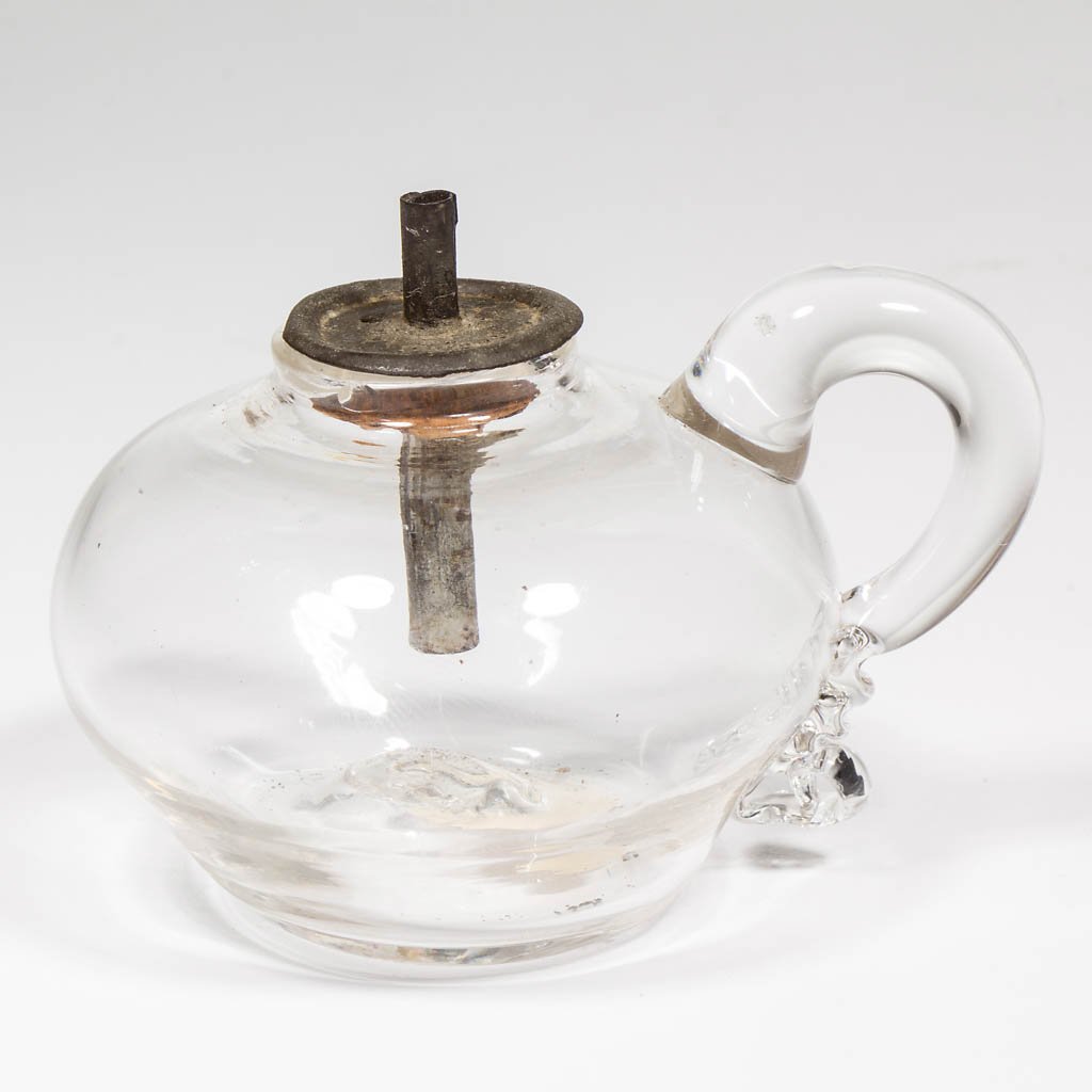 FREE-BLOWN WHALE OIL MINIATURE / TOY FINGER LAMP: FREE-BLOWN WHALE OIL MINIATURE / TOY FINGER LAMP, colorless, compressed globular form with applied handle, kick-up base with rough pontil mark. Fitted with a period tin and cork single-tube drop-in bu