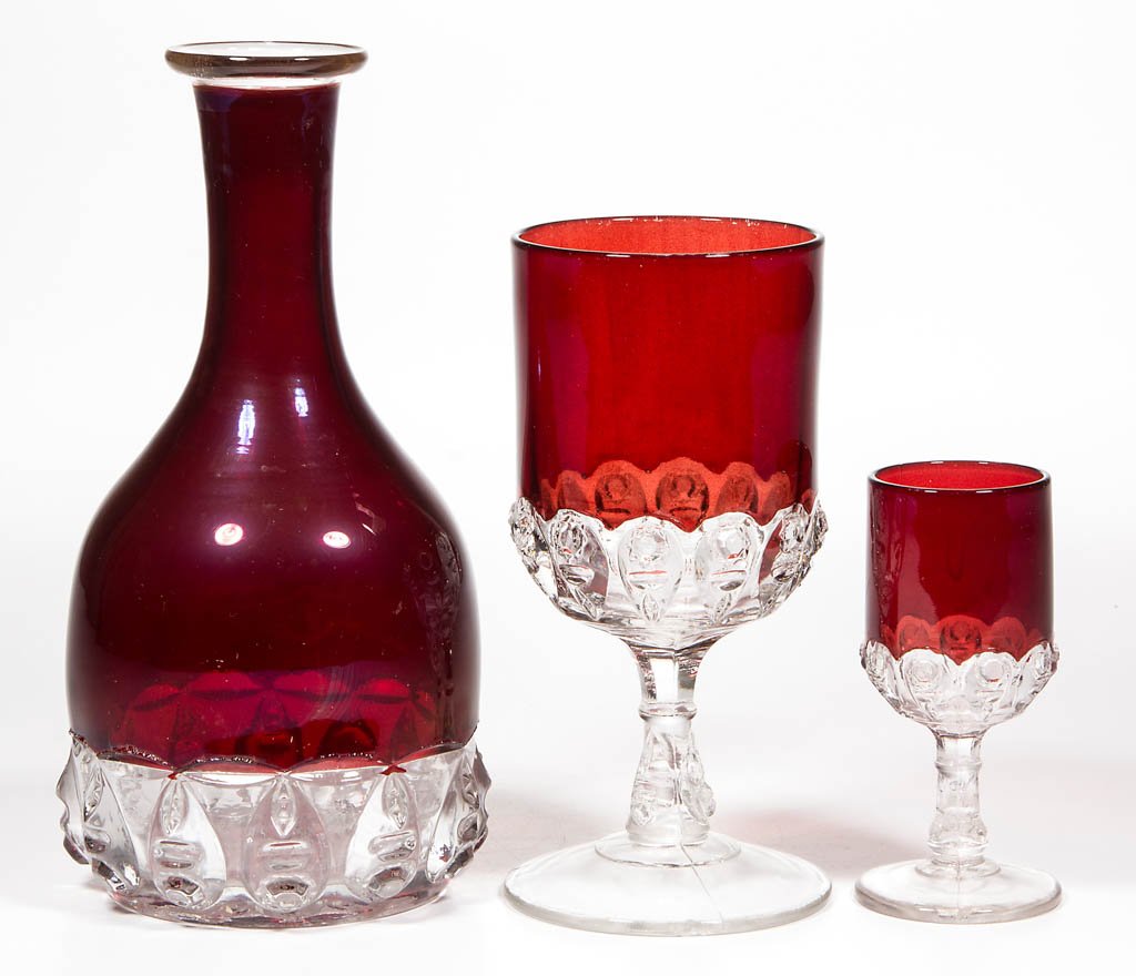 THOMPSON NO. 17 / TORPEDO - RUBY-STAINED DRINKING: THOMPSON NO. 17 / TORPEDO - RUBY-STAINED DRINKING ARTICLES, LOT OF THREE, colorless, comprising a wine decanter, goblet, and wine. Thompson Glass Co. Pattern introduced in 1889. 4 1/8" to 8" H. Proven