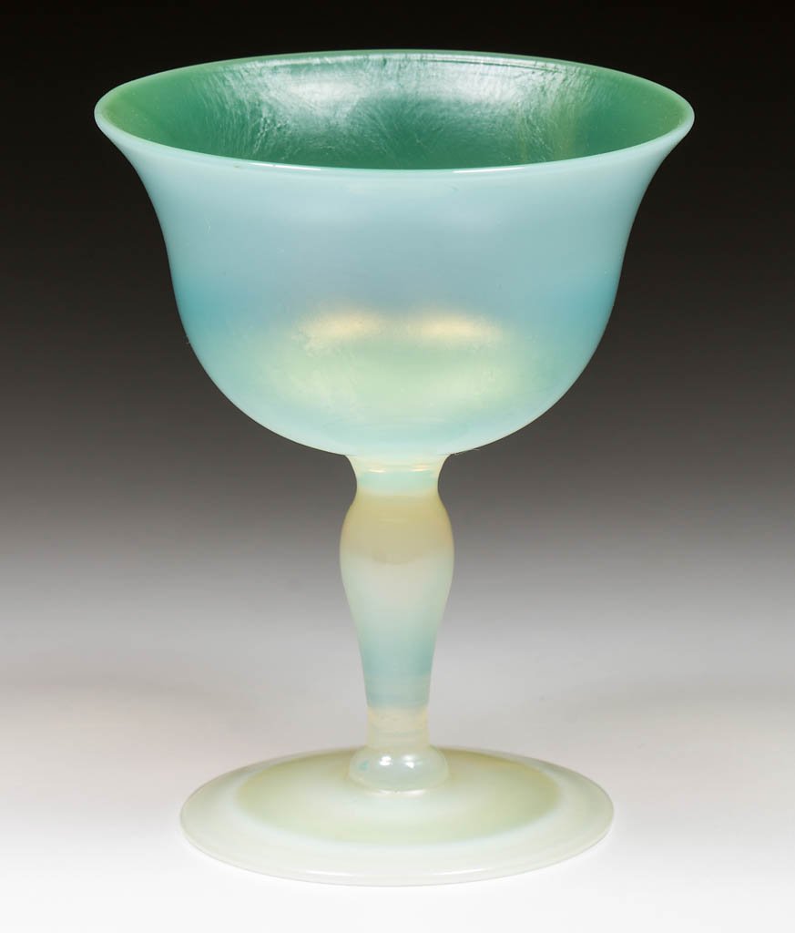 TIFFANY FAVRILE PASTEL WINE: TIFFANY FAVRILE PASTEL WINE, opalescent with green iridescence, factory polished foot, signed, "L.C.T. Favrile". Tiffany Studios. Circa 1930. 3 7/8" H. Undamaged. Provenance: From the collection of th